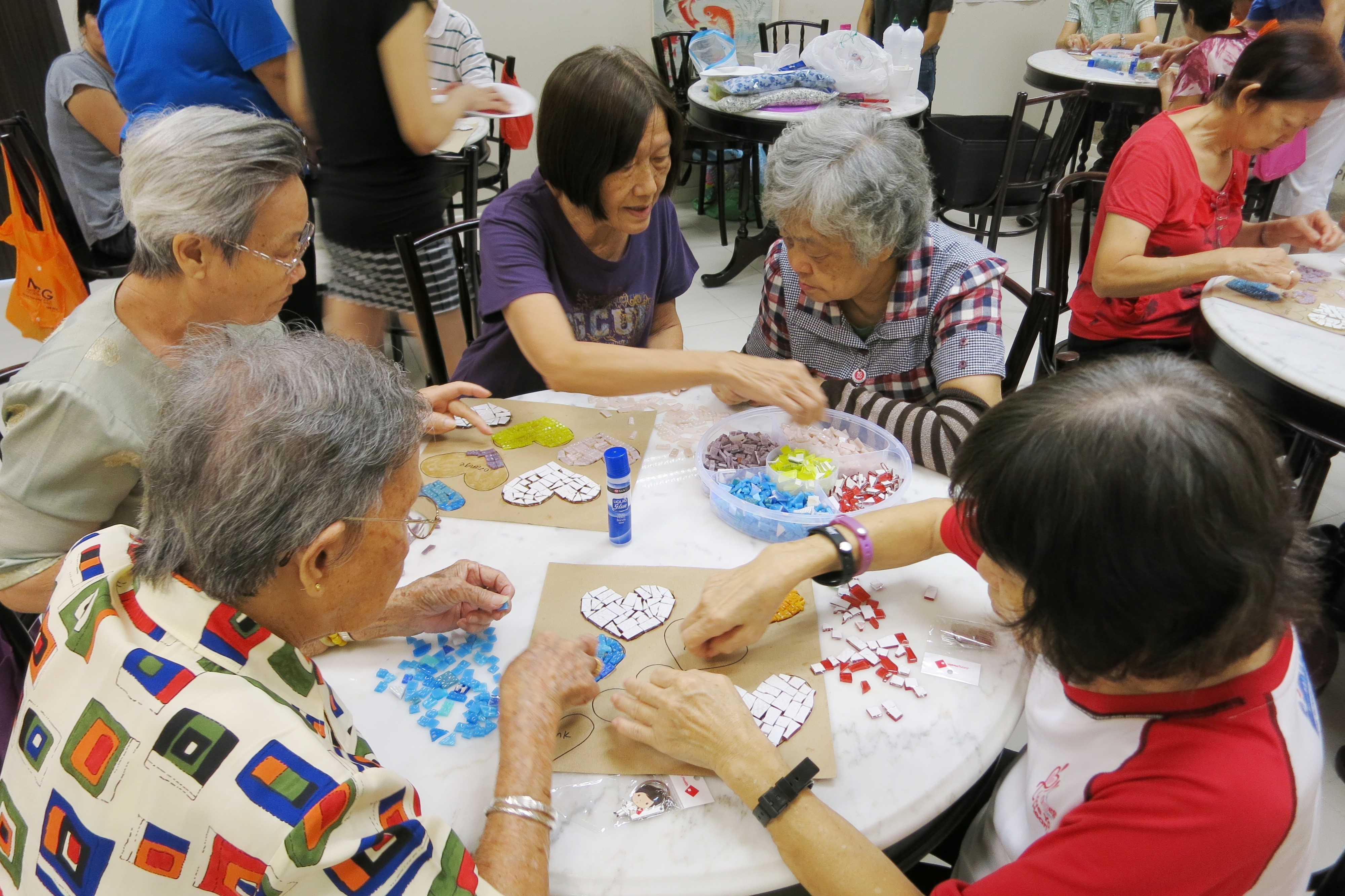 Seniors doing mosaic artworks